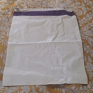 Tory Burch drawstring dustbag with charm